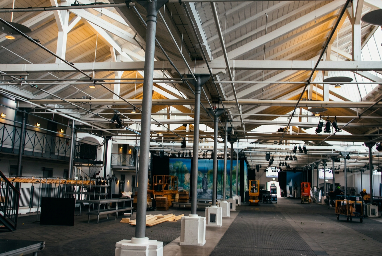 Interior of Øksnehallen showing the great timber roof, steel ties and cast-iron columns of the former cattle hall.