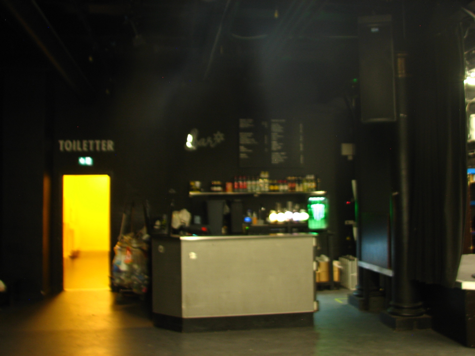 Dark interior of Pumpehuset concert hall with bar