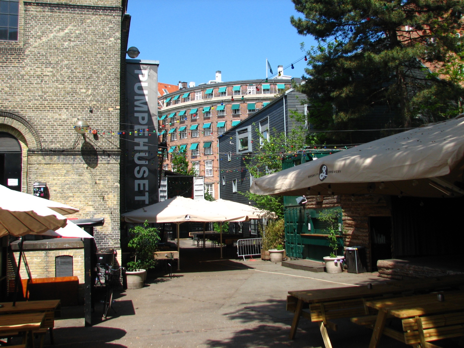 Pumpehuset courtyard with parasols and string lights