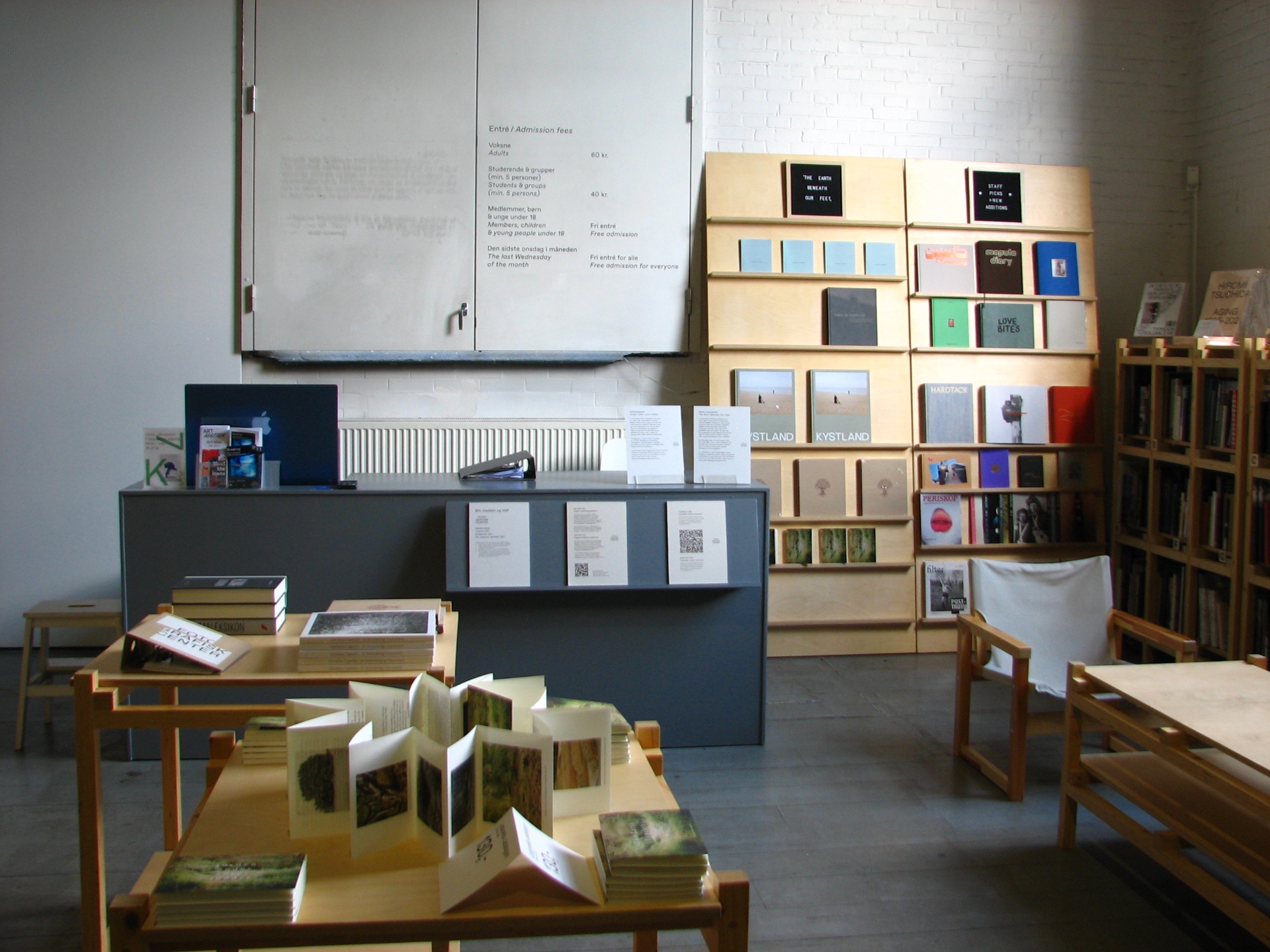 The interior of a photography centre bookshop near Øksnehallen, with shelves of photobooks and a reading corner.